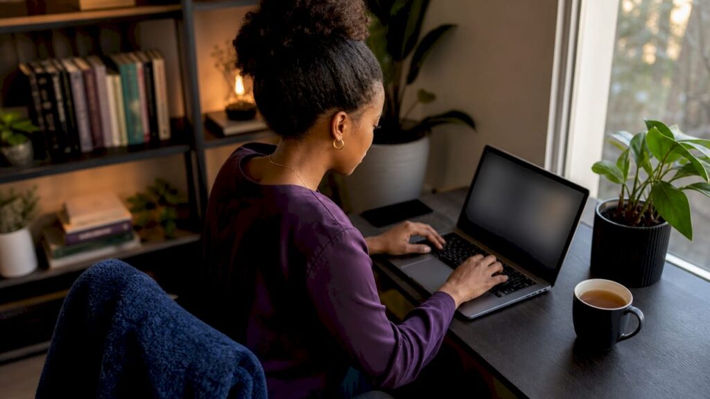 Person using laptop to search mental health directory at home