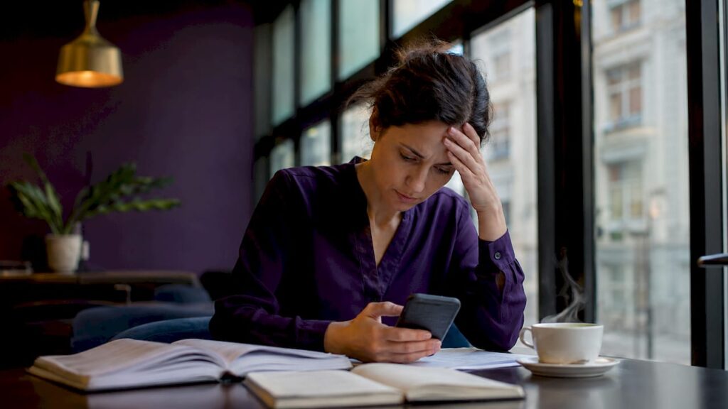 Woman experiencing workplace stress at home desk