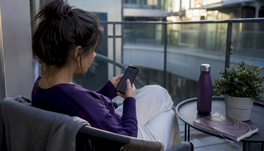 Person setting emergency contacts on smartphone